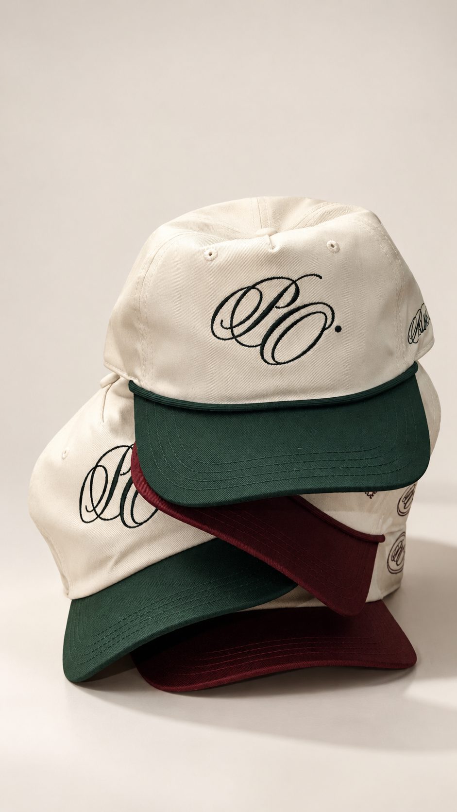 Stack of Palms Out caps with moss green and burgundy peaks