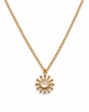 Gold necklace with a sun-shaped pendant featuring a white gemstone on a white background