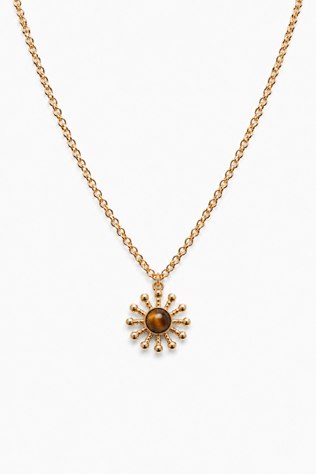 Gold necklace with a sun-shaped pendant on a white background