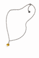 Paperclip chain necklace, stainless steel with a yellow gemstone on a white background
